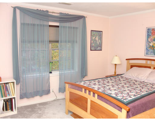 141 Lake Shore Road, Unit 3 Boston, MA 02135 - Photo 7 of 20 a bedroom with a bed and a rug