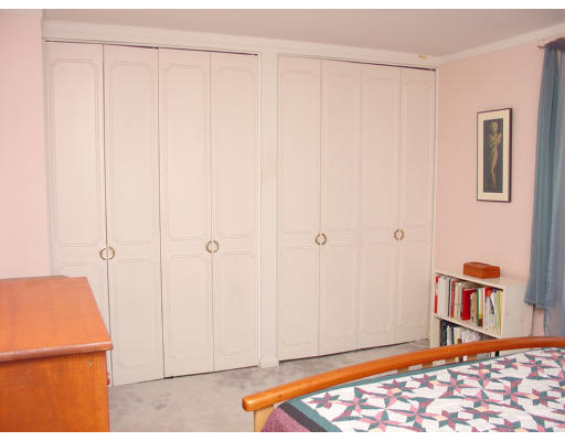 141 Lake Shore Road, Unit 3 Boston, MA 02135 - Photo 8 of 20 a bedroom with a bed and a book shelf