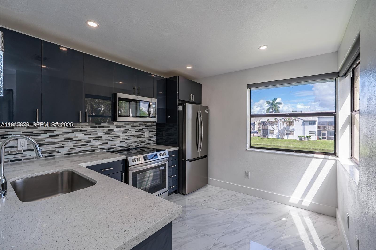 1031 Adams Avenue, Unit 1031I Homestead, FL 33034 - Photo 1 of 33 a kitchen with stainless steel appliances granite countertop a sink stove and refrigerator