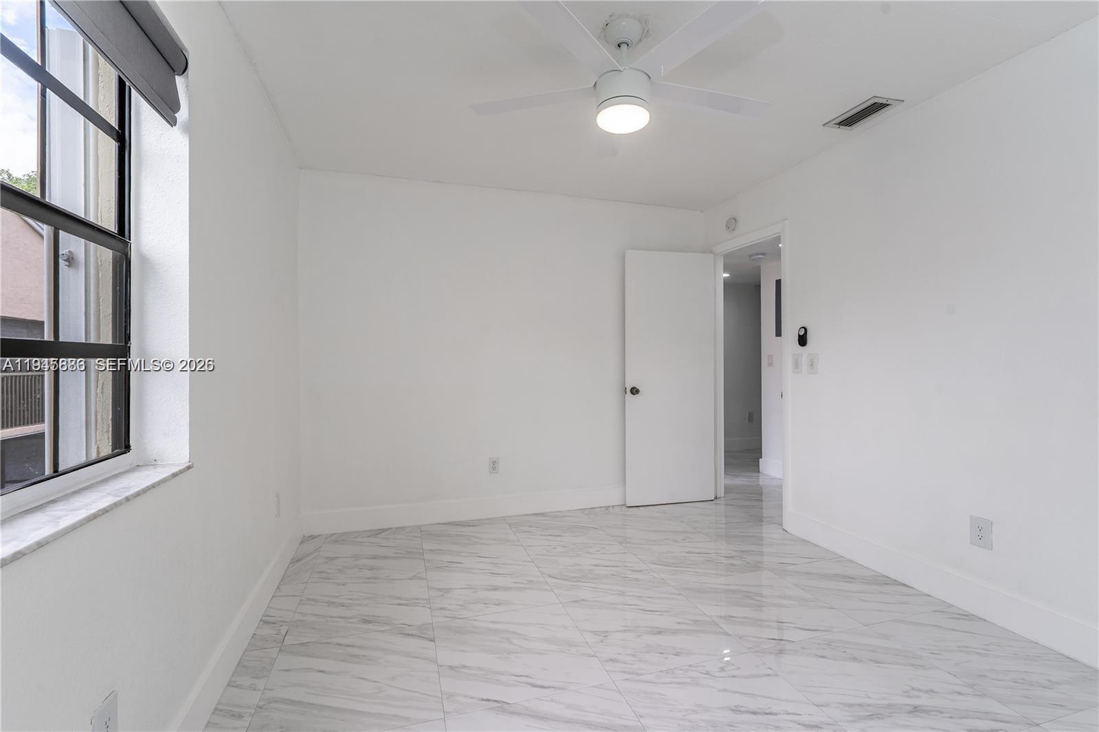 1031 Adams Avenue, Unit 1031I Homestead, FL 33034 - Photo 16 of 33 wooden floor in an empty room