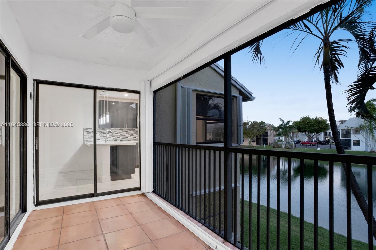 1031 Adams Avenue, Unit 1031I Homestead, FL 33034 - Photo 23 of 33 a view of a hallway with wooden floor and a floor to ceiling window