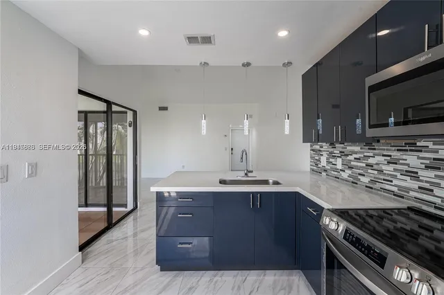 a kitchen with stainless steel appliances granite countertop a stove and a sink