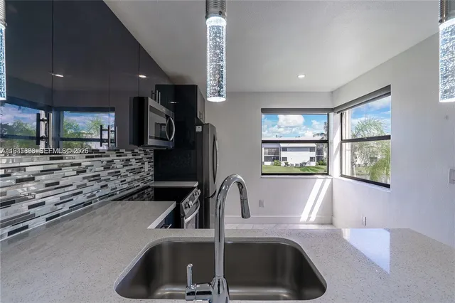 a kitchen with a sink and a refrigerator