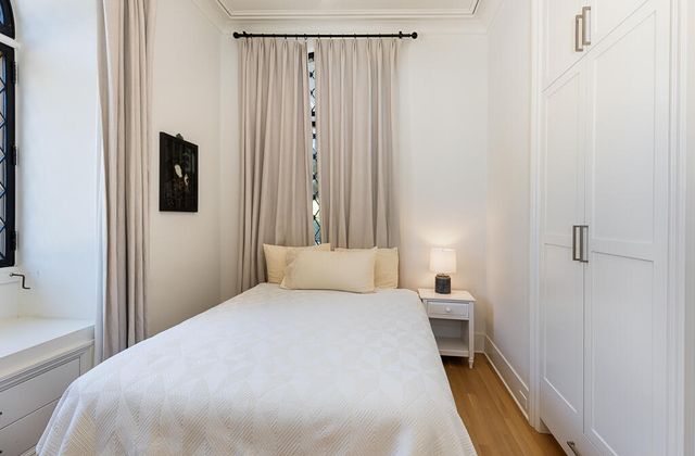 a bedroom with a bed and a mirror