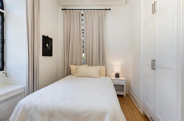 a bedroom with a bed and a mirror