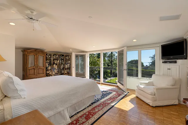 a living room with furniture large window and flat screen tv