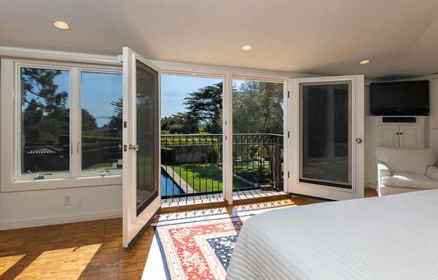 a bedroom with a bed and a large window