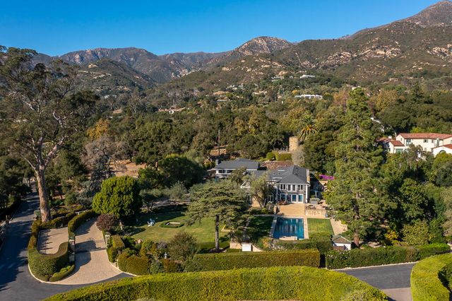 an aerial view of residential houses with yard