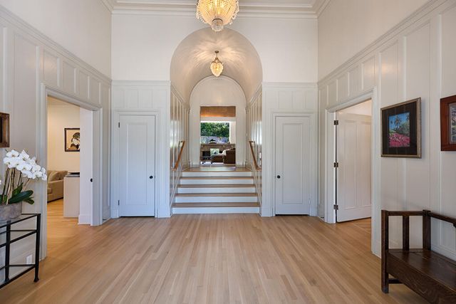 a view of a hallway view with wooden floor and staircase