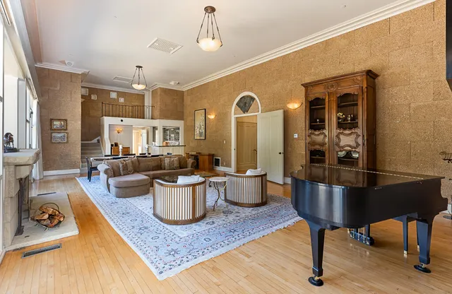a living room with furniture a rug and a chandelier