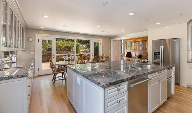 a kitchen with stainless steel appliances granite countertop a stove and a sink