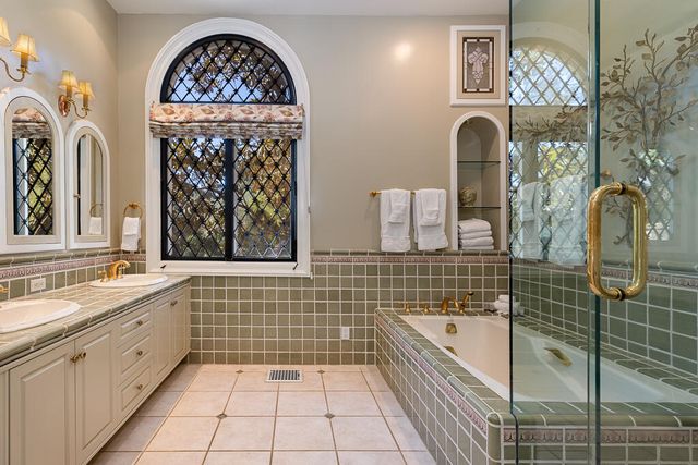 a bathroom with a sink a mirror and a bathtub