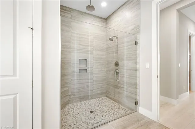 an aerial view of a pool with chairs and a table