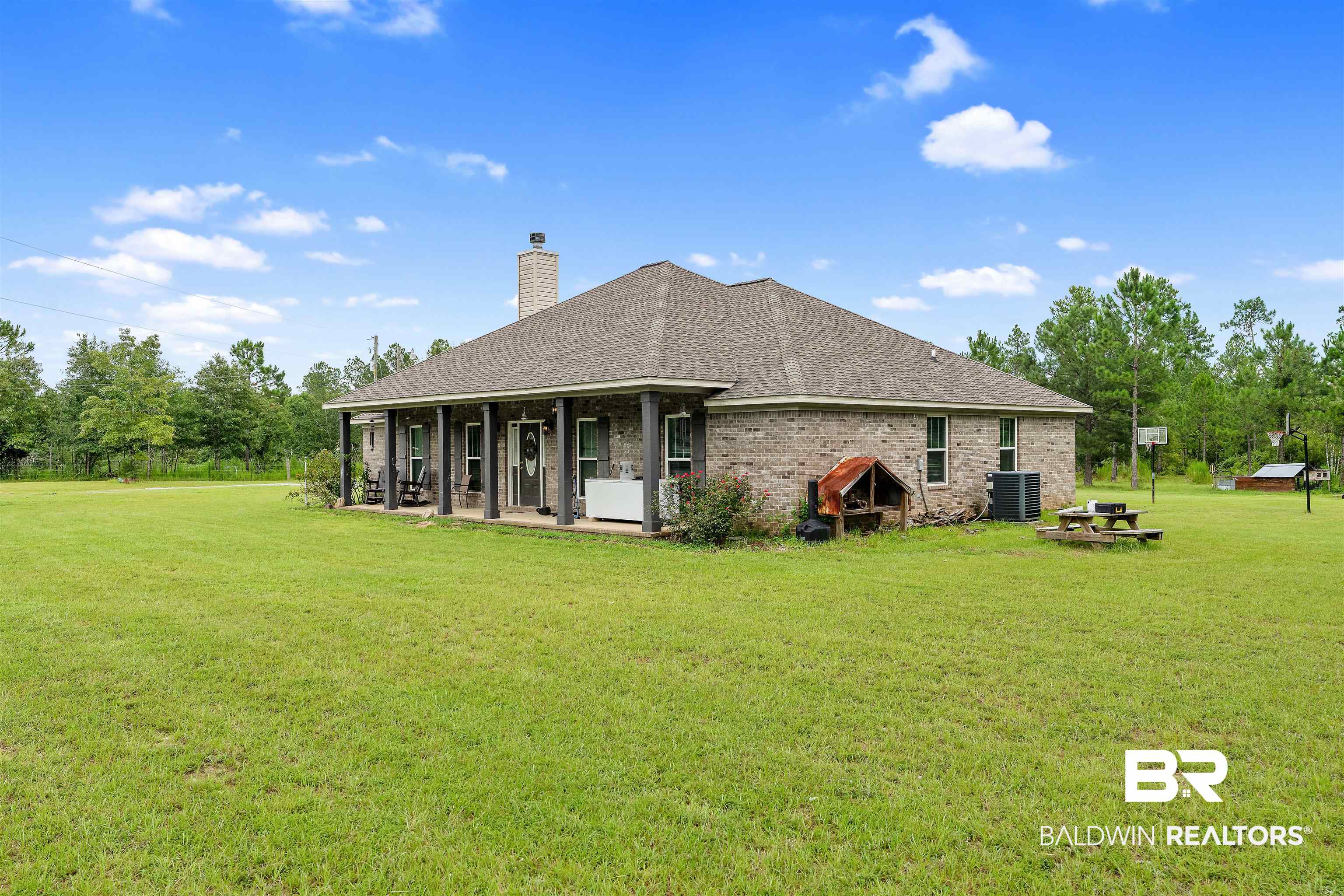 20076 Patty Jr Lane Bay Minette, AL 36507 - Photo 25 of 31 Rear view of property featuring central air condition unit and a lawn