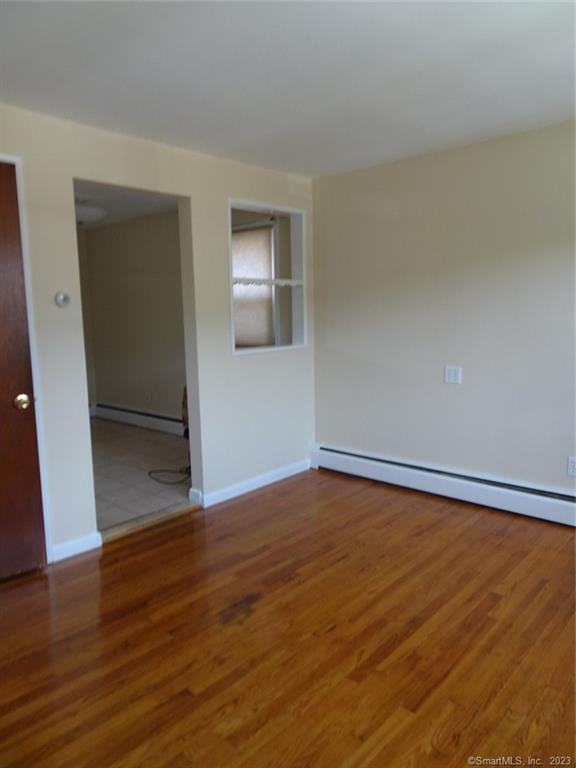 7 Eclipse Avenue, Unit B Norwalk, CT 06851 - Photo 2 of 14 a view of an empty room with wooden floor and a window