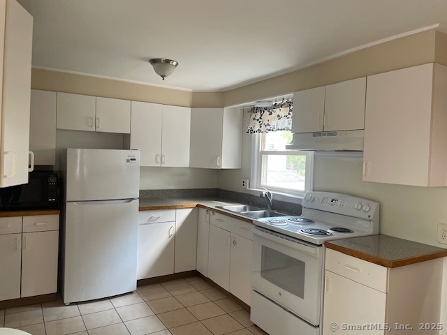 7 Eclipse Avenue, Unit B Norwalk, CT 06851 - Photo 4 of 14 a white kitchen with sink and white stainless steel appliances