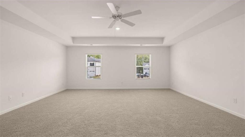314 Friendship Oak Way Hampton, GA 30228 - Photo 13 of 32 an empty room with a window and a ceiling fan