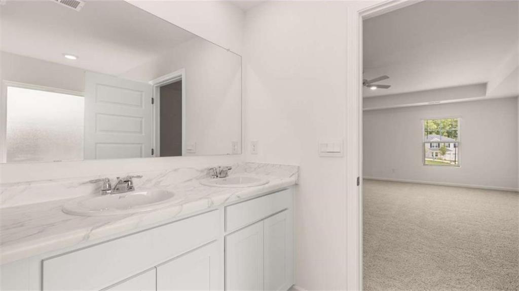 314 Friendship Oak Way Hampton, GA 30228 - Photo 17 of 32 a bathroom with a sink and a mirror