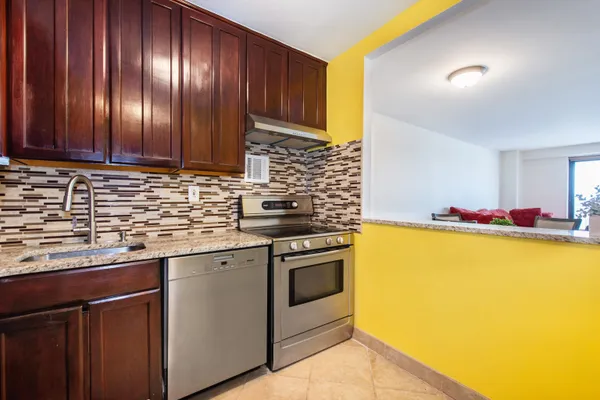 a kitchen with stainless steel appliances granite countertop a refrigerator stove a sink and dishwasher