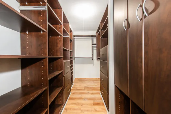a bathroom with a sink and mirror with bathtub