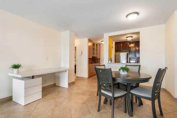 a dining room with furniture and window