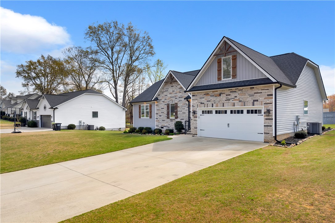 181 Amberwood Drive Anderson, SC 29621 - Photo 3 of 28 This charming residence boasts a stone and siding facade, with a welcoming garage and well-maintained grounds.