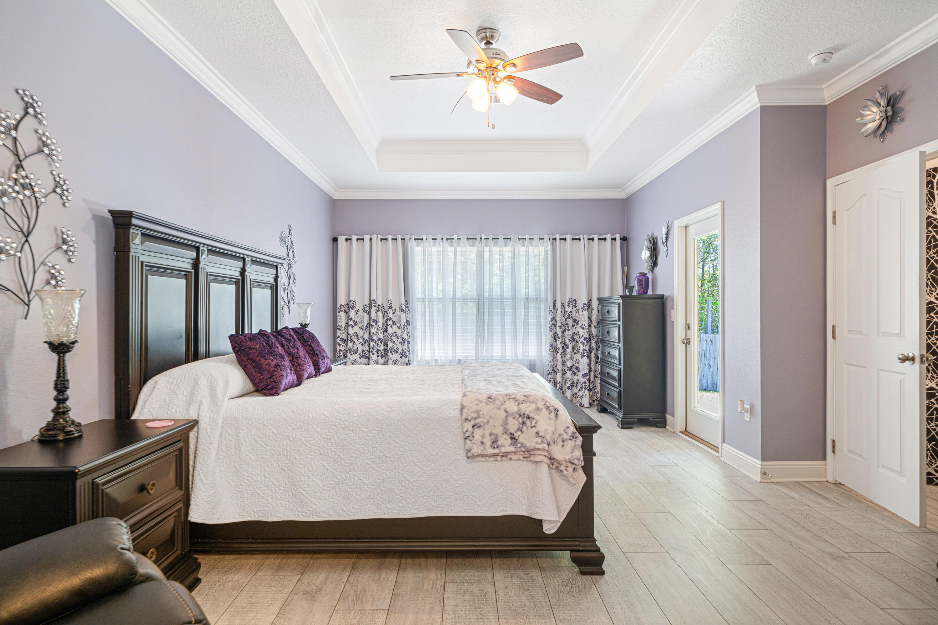 634 Red Fern Road Crestview, FL 32536 - Photo 11 of 21 a bedroom with a large bed chandelier and a window