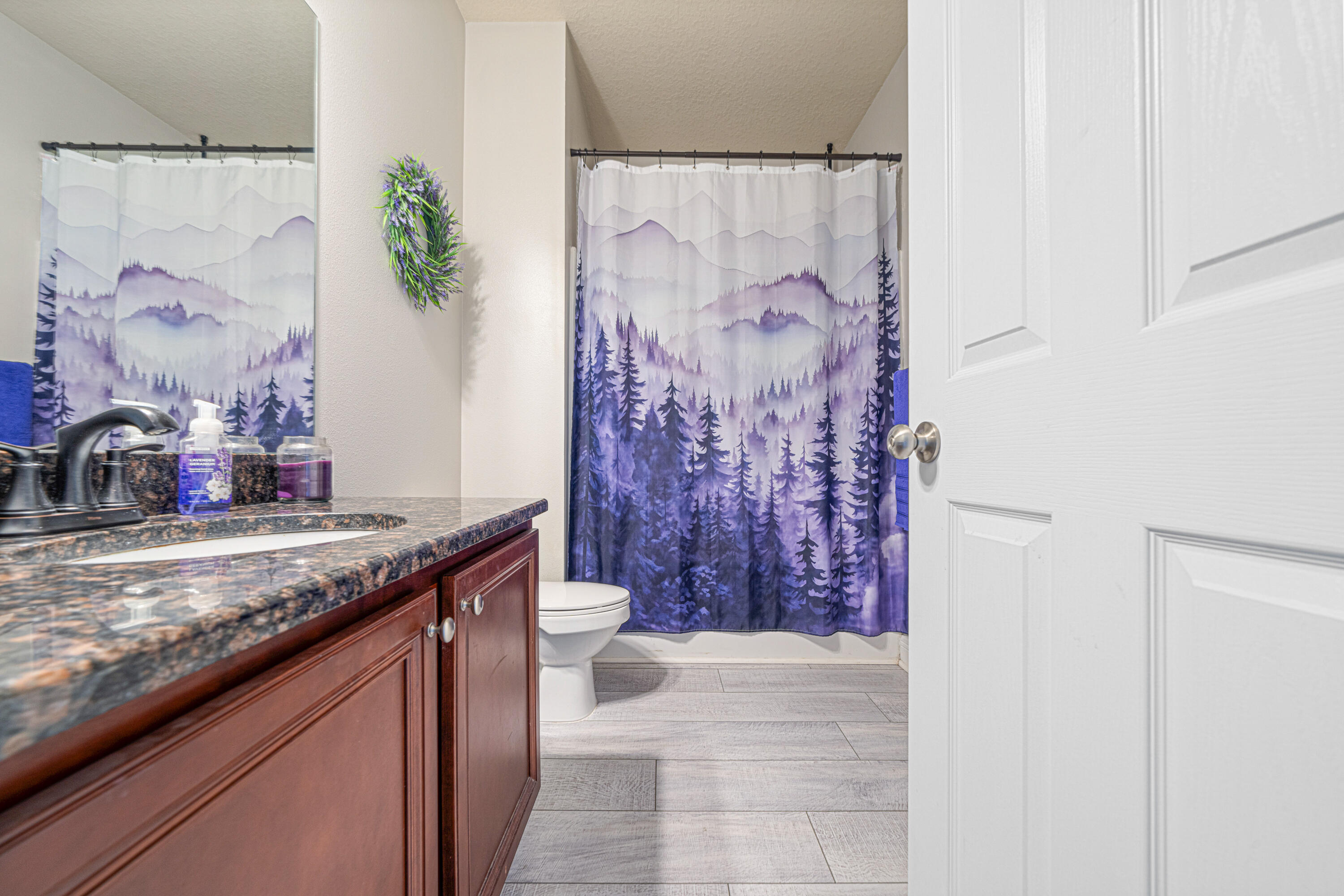 634 Red Fern Road Crestview, FL 32536 - Photo 17 of 21 a bathroom with a granite countertop sink a toilet and a shower curtain