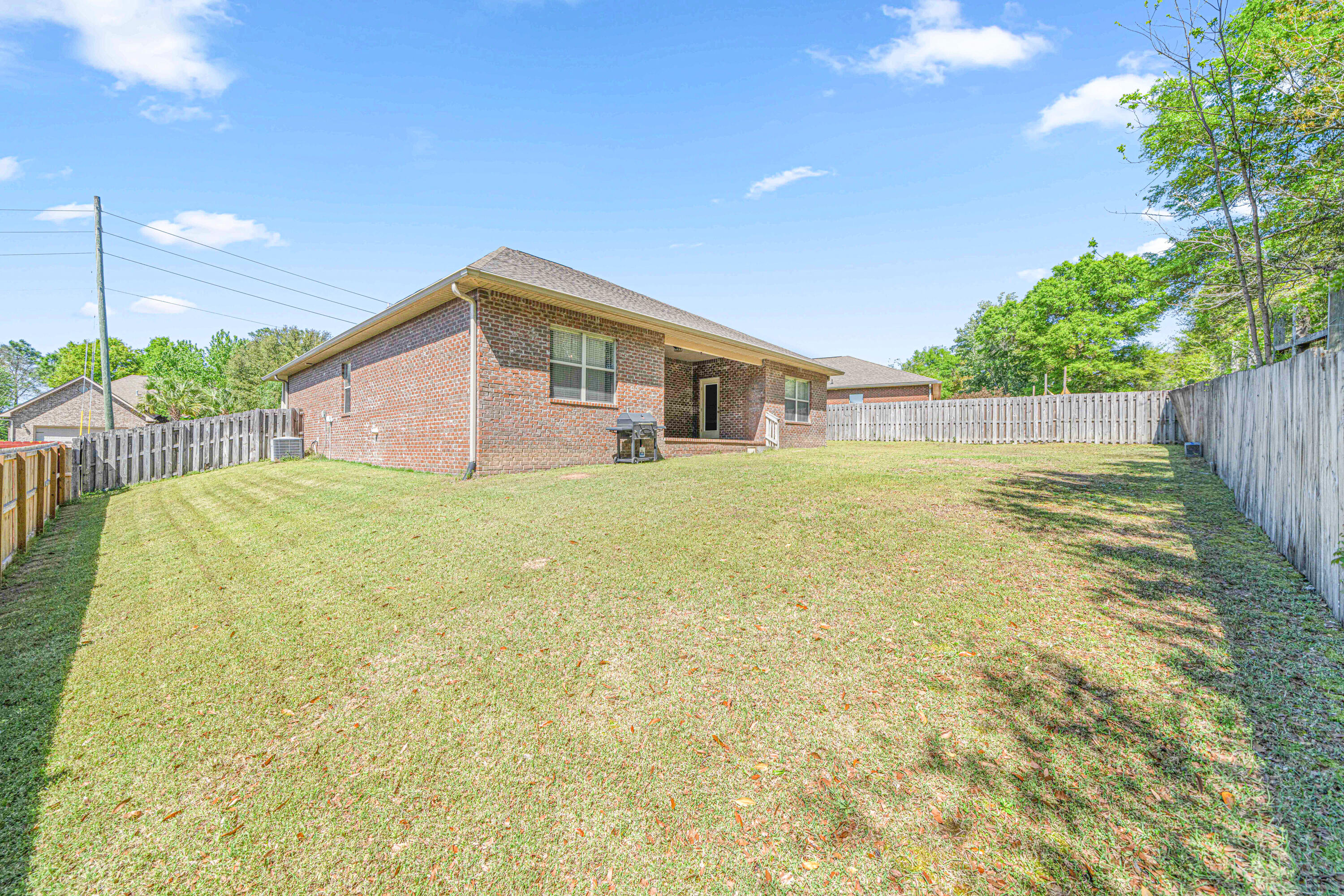 634 Red Fern Road Crestview, FL 32536 - Photo 19 of 21 a view of a house with a yard and potted plants