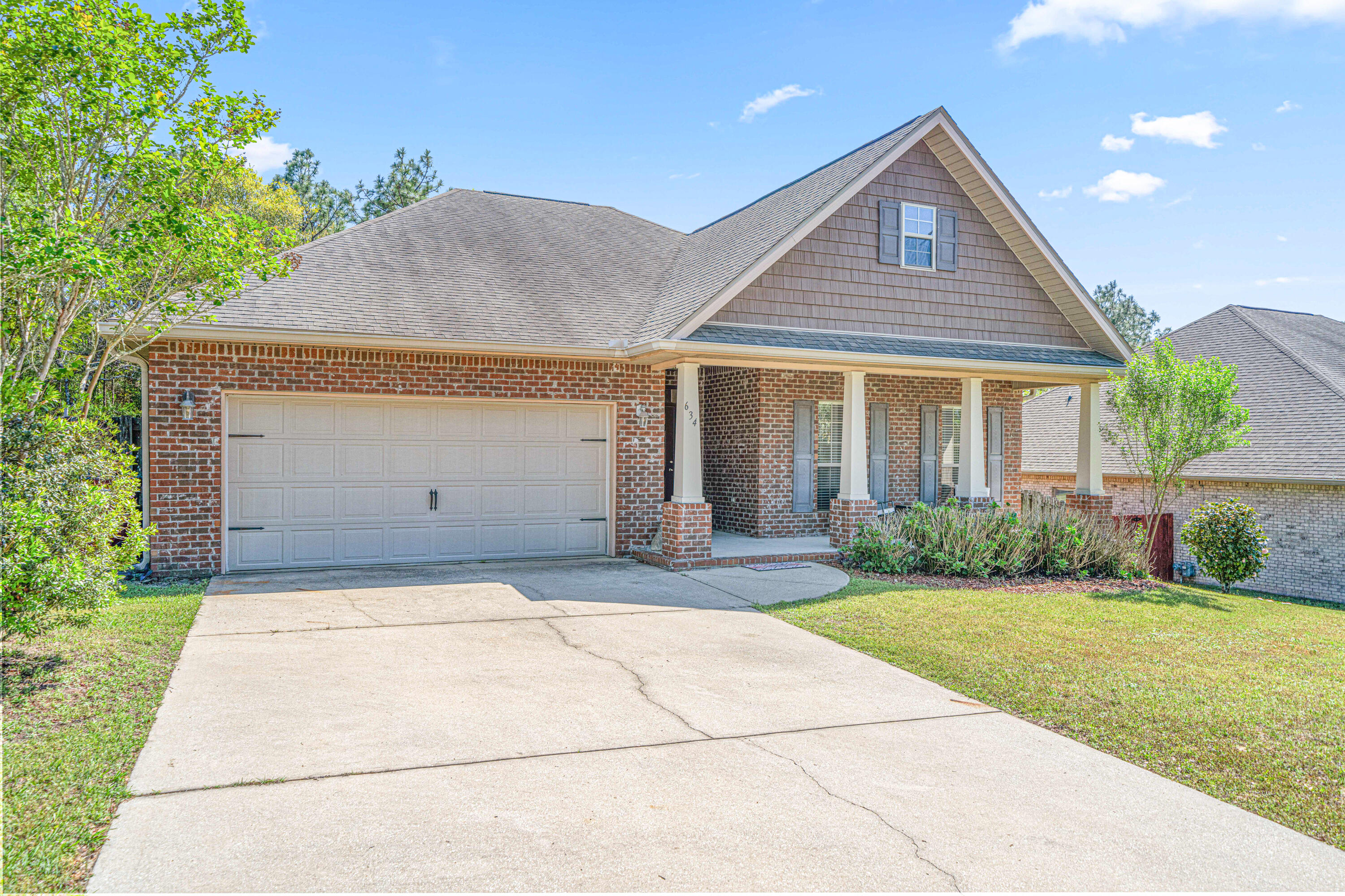 634 Red Fern Road Crestview, FL 32536 - Photo 2 of 21 a front view of a house with garden
