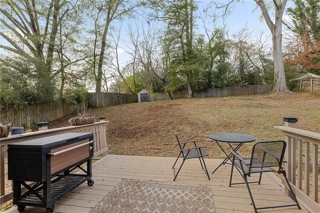 a view of backyard with seating and trees