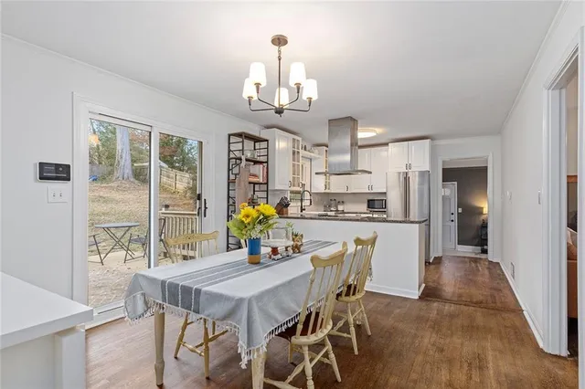 a view of a dining room with furniture and a chandelier