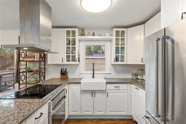 a kitchen with stainless steel appliances granite countertop a sink stove and refrigerator