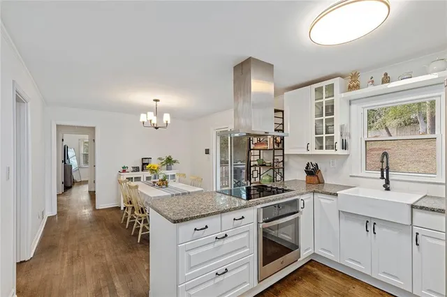 a kitchen with a sink stove and cabinets
