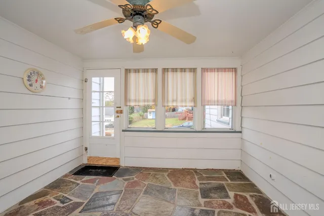 a view of empty room with window and hardwood floor