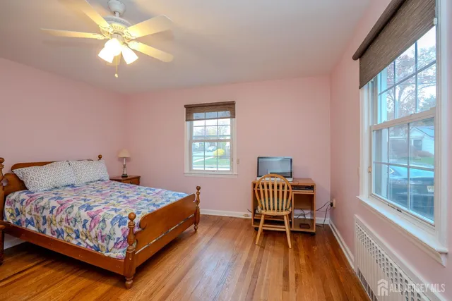 a bedroom with a bed chairs and a window