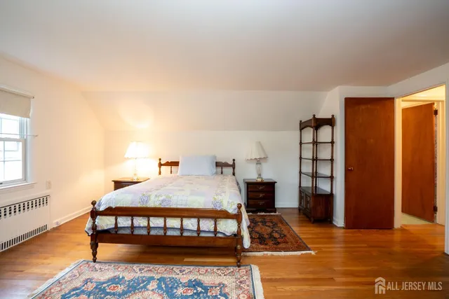 a bedroom with a bed and a rug