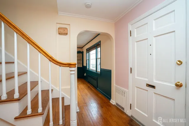 a view of entryway with wooden floor and stairs