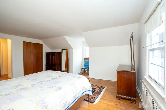 a bedroom with a bed and a large window