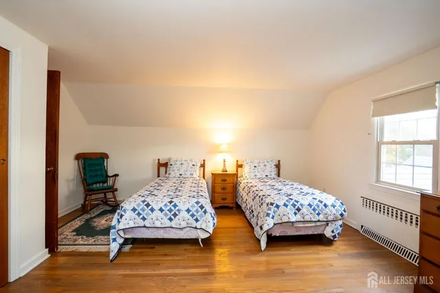 a bedroom with two beds and lamp