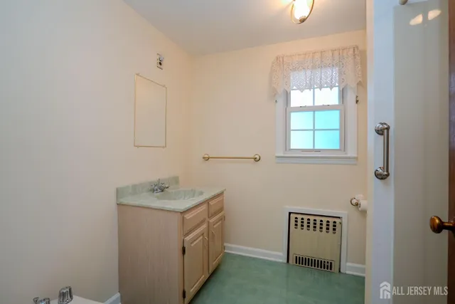 a bathroom with a sink a vanity and a window