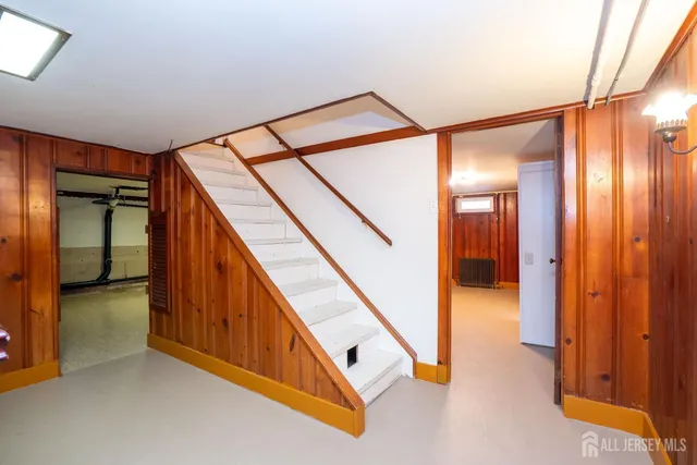a view of hallway with stairs and a chandelier