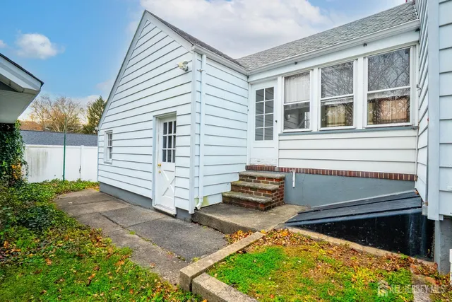 a front view of a house with a garden and yard