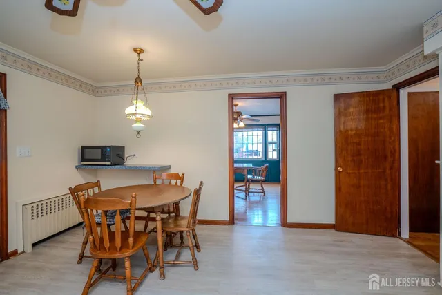 a view of a dining room with furniture and window