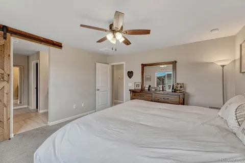 a bedroom with a large bed and chandelier