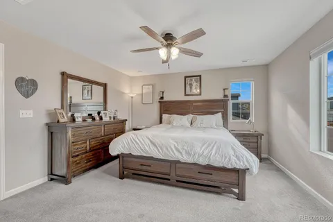 a bedroom with a bed and ceiling fan