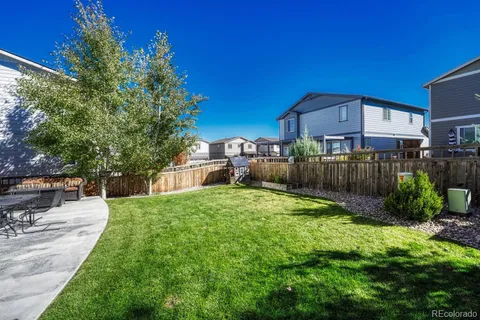 a house view with a sitting space and garden