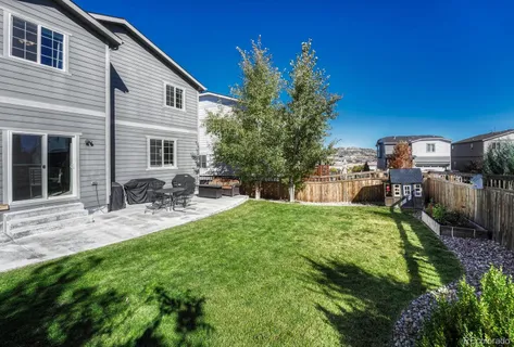 a backyard of a house with table and chairs