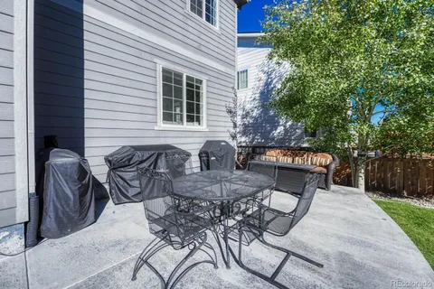 a view of a patio with table and chairs and potted plants