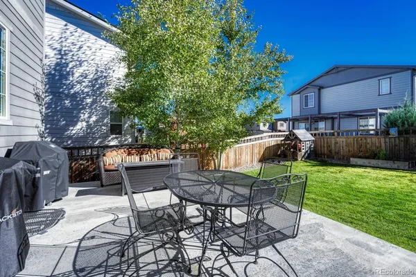 a view of a chairs and table in backyard of the house